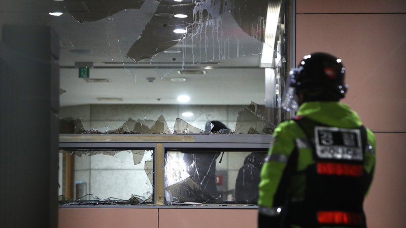 Protesters blasted fire extinguishers at lines of police guarding the front entrance, then flooded inside, destroying office equipment, fittings and furniture, footage showed