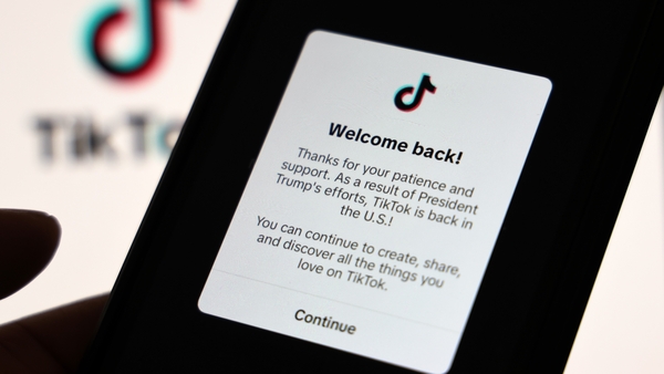 A smartphone displays a popup message on the social media platform TikTok welcoming users back