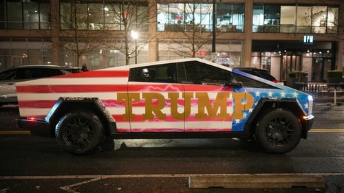 A Donald Trump-adorned Tesla Cybertruck sits in traffic on 19 January in Washington, DC