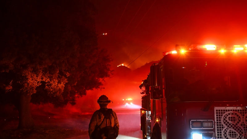 Firefighters battle with flames from the 'Hughes Fire' in the Castaic area