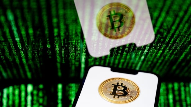 a close up of a phone with a bitcoin symbol against laser beams background