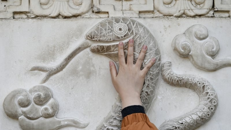 A snake figure on the wall of the Baiyun Taoist Temple in Beijing (Pic: Getty)