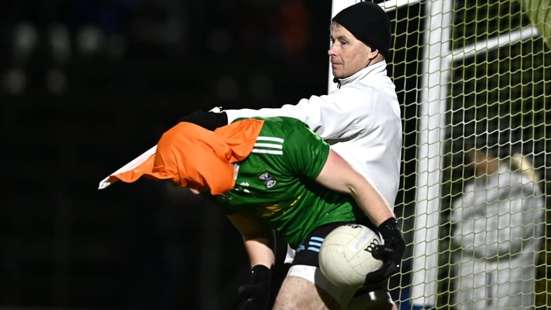Cavan goalkeeper Gary O'Rourke gets caught up in the umpire's orange flag after a Monaghan two-pointer