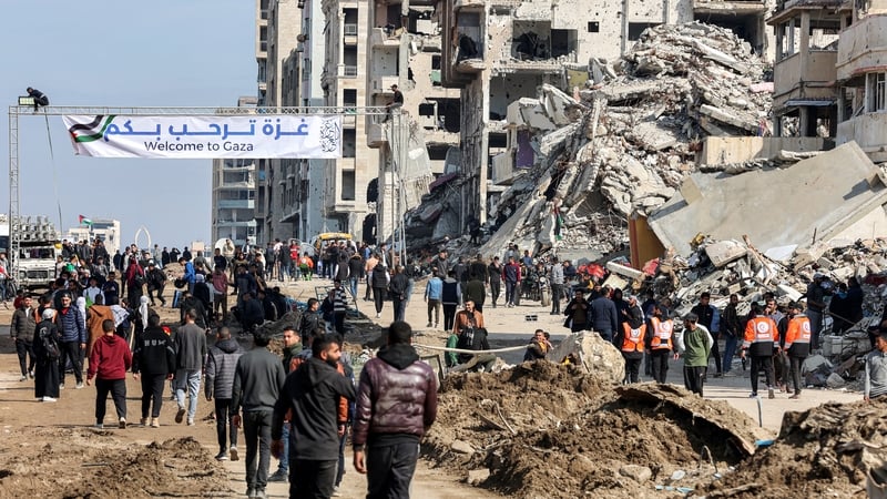 People gather along al-Rashid Street to cross from the Israeli-blocked Netzarim Corridor from southern Gaza into Gaza city in the north