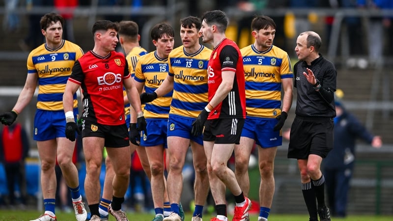 Referee Niall Cullen explains a decision to Down and Roscommon players during their Division 2 clash