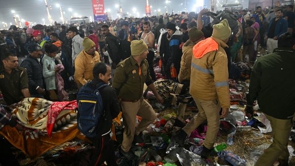 Police personnel carry the injured after a stampede at the Maha Kumbh Mela festival in Prayagraj