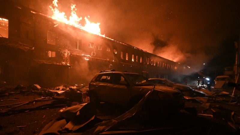Rescuers of the Ukraine's state emergency service work to extinguish a fire in a building after a drone strike in Kharkiv