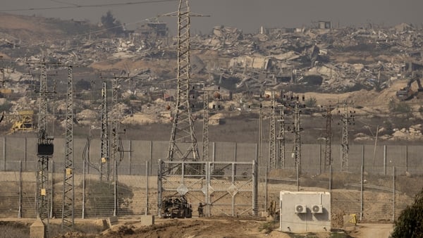 An Israeli soldier opens a gate at the border with northern Gaza