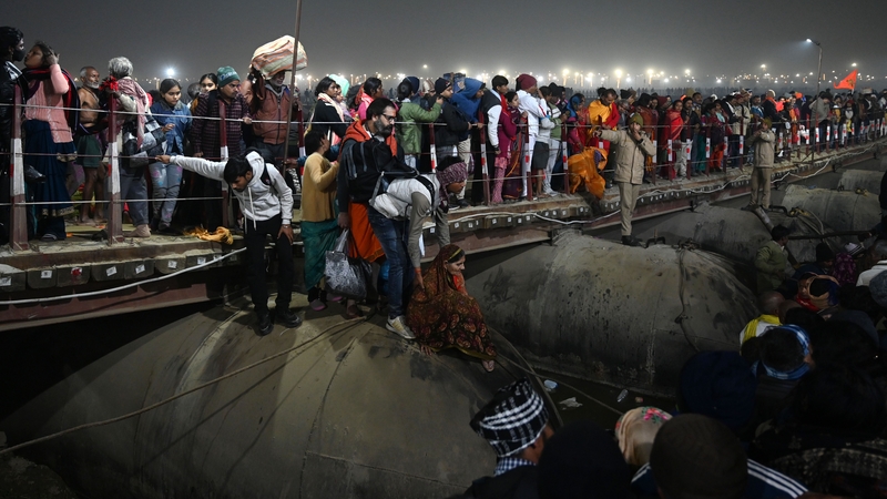Devotees trying to cross the barricades after a deadly stampede at the Maha Kumbh Mela Hindu festival