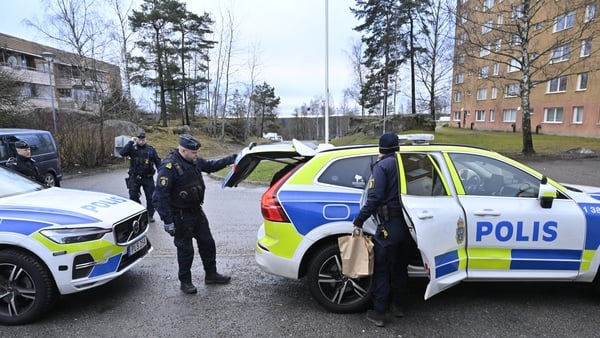 Policemen are seen in front of an apartment building in Södertälje, south of Stockholm
