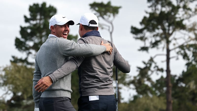 Rory McIlroy (L) celebrates his hole-in-one
