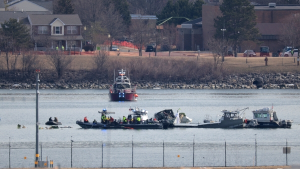 Emergency response units search the crash site of the American Airlines plane on the Potomac River after the plane crashed on approach to Reagan National Airport