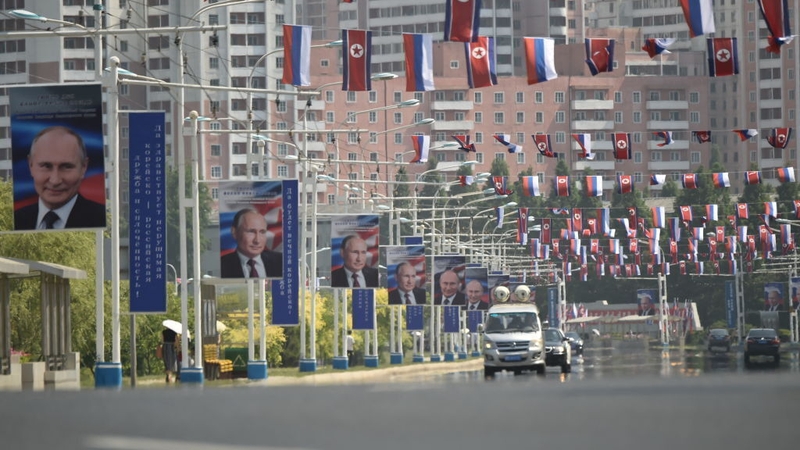 Portraits of Russian President Vladimir Putin are seen near national flags of North Korea and Russia in Pyongyang (file image)