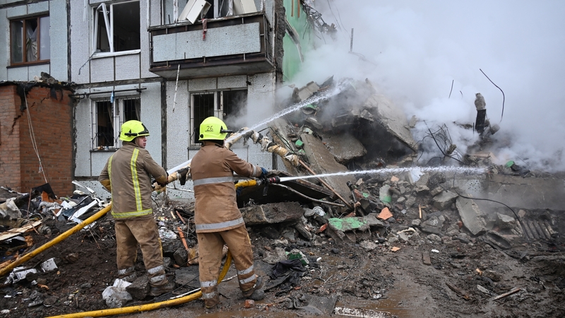 Firefighters are at work to put out a fire that broke out in a heavilydamaged residential building following a missile strike in Poltava