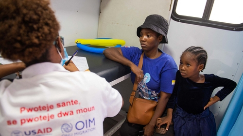 A woman and her daughter attend a medical consultation at a mobile clinic operated by the Institute for Population Health and Development, in partnership with USAID and IOM in Haiti