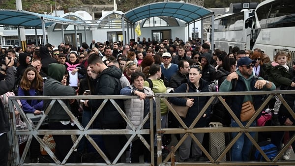 People queue to get a ferry off the island of Santorini after 'intense' tremors