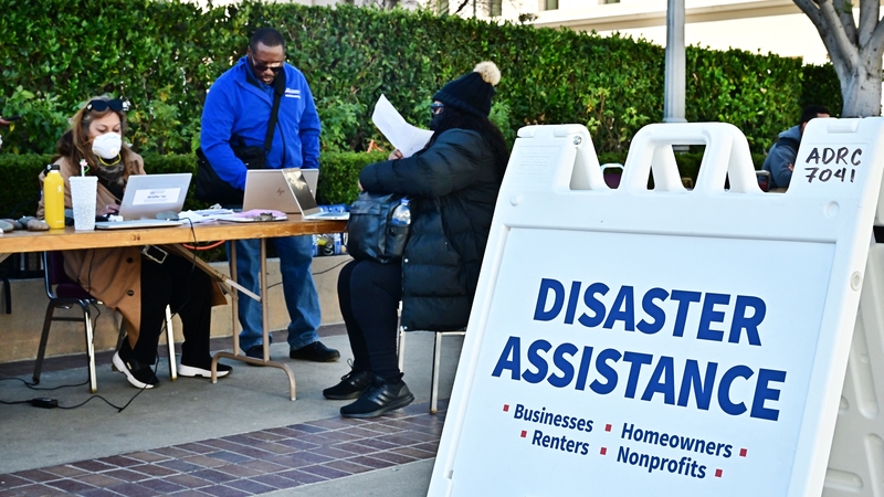 People impacted by the Eaton Fire meet FEMA and SBA officials for disaster assistance at the Pasadena Convention Center in California