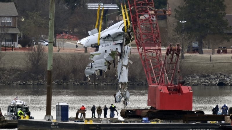 A crane pulls up a portion of the fuselage of the Bombardier CRJ-700 plane