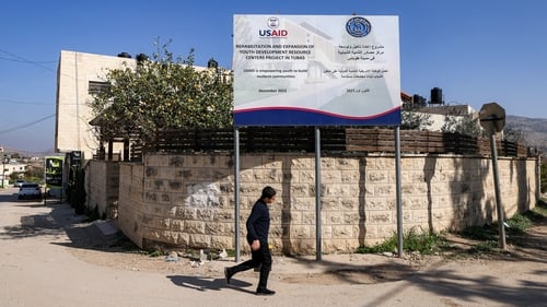 A boy walks past a USAID-funded project for a youth centre in Tubas in the north of the occupied West Bank