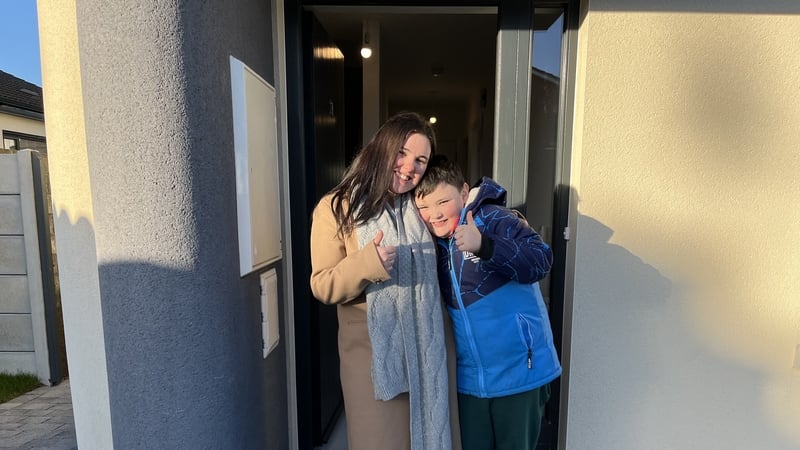 Shannon Norton and son TJ outside their new 3D printed home in Grange Close in Dundalk