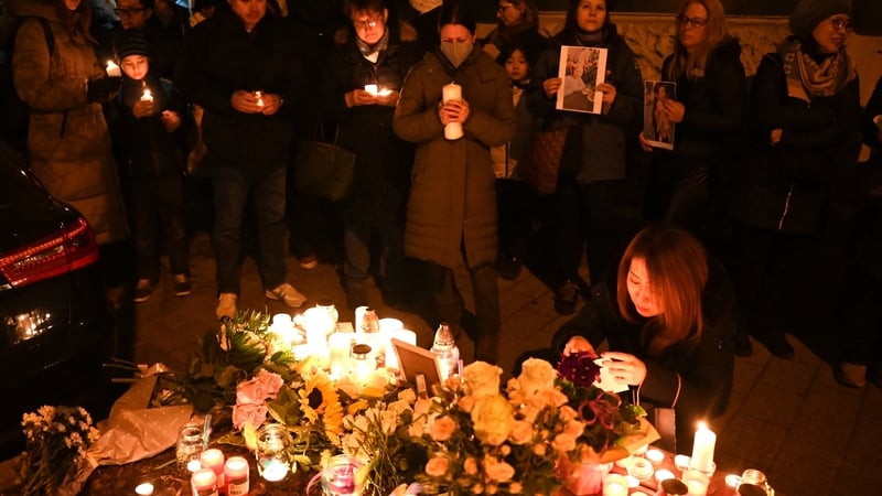People attend a vigil in central Budapest to commemorate the 43-year-old Japanese woman who died