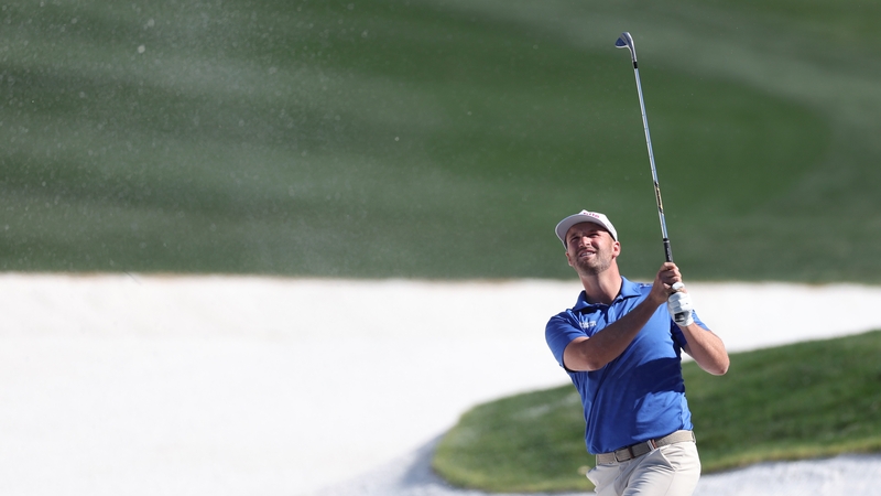 Wyndham Clark plays a shot from a bunker on the third hole