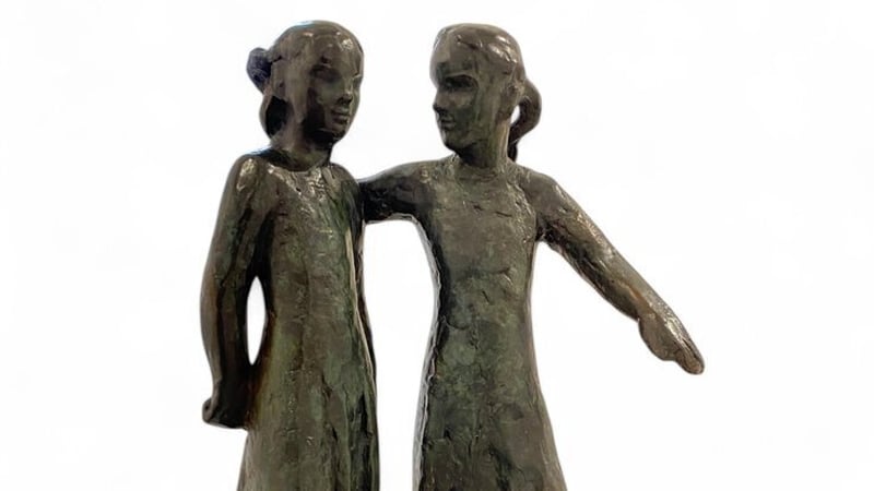 Life size bronze figures located on Portland Row in Dublin, of two children playing street games