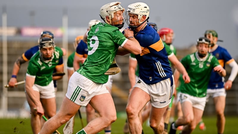 Cian Lynch of Limerick and Tipperary's Michael Breen battle for possession
