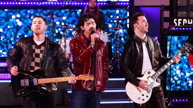 Jonas Brothers have thanked their fans for two decades of growing "up together"