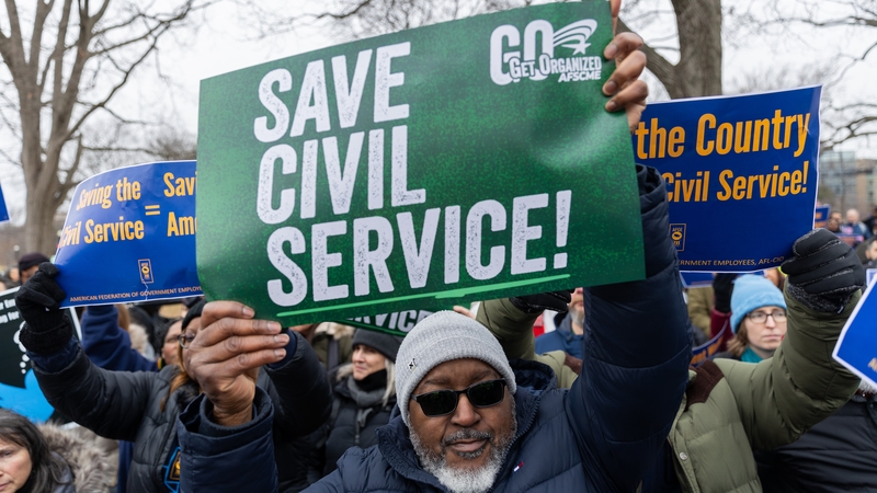 Federal employees protest near the White House over the job cutting measures