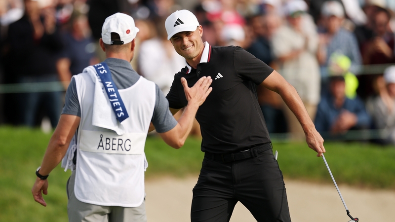 Ludvig Aberg of Sweden celebrates with his caddie following his final round