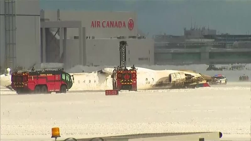 Emergency services respond after a Delta Air Lines aircraft overturned upon landing at Toronto Pearson International Airport