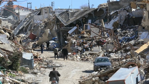 People inspect their destroyed homes in the southern Lebanese village of Adaisseh after the partial withdrawal of Israeli troops