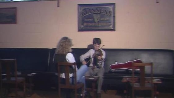 Clíona Ní Bhuachalla listens to fiddle player Ivan O'Connor, Co. Clare (1990)