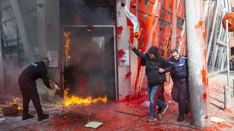 Protesters set fire to the door of the EU mission building in Sofia