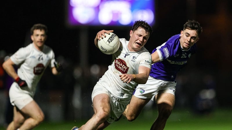 Alex Beirne of Kildare gets past the challenge of Ben Dempsey