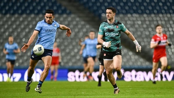 Derry goalkeeper Neil McNicholl can only look as Niall Scully of Dublin goes on the attack