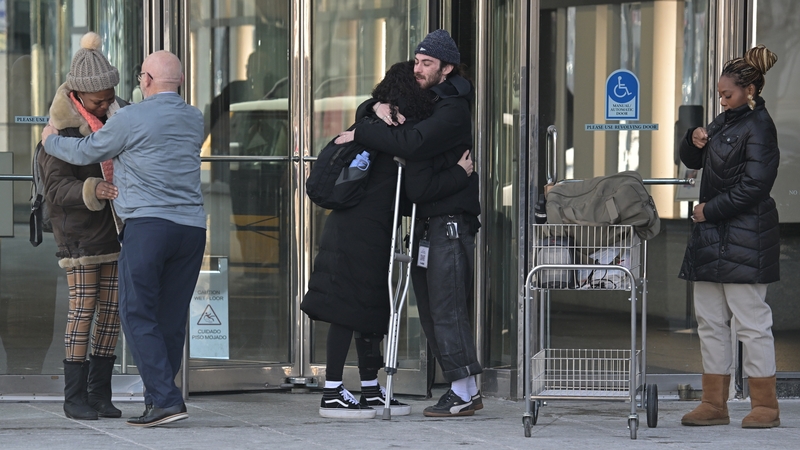 Internal Revenue Service workers leave their office after being laid off in downtown Denver, Colorado on 20 February