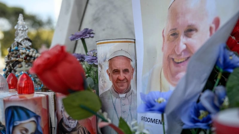 Candles with a portrait of Pope Francis are seen outside the hospital where Pope Francis is hospitalised for pneumonia