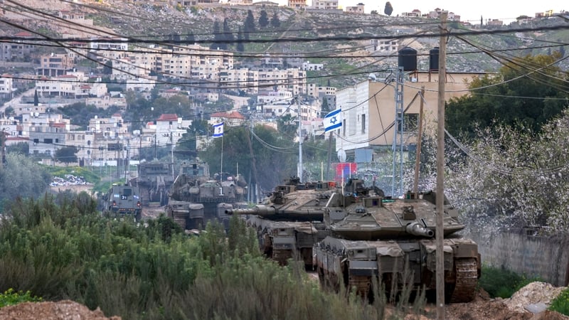 Israeli tanks and bulldozers take positions yesterday evening in the Jenin camp for Palestinian refugees, in the occupied West Bank
