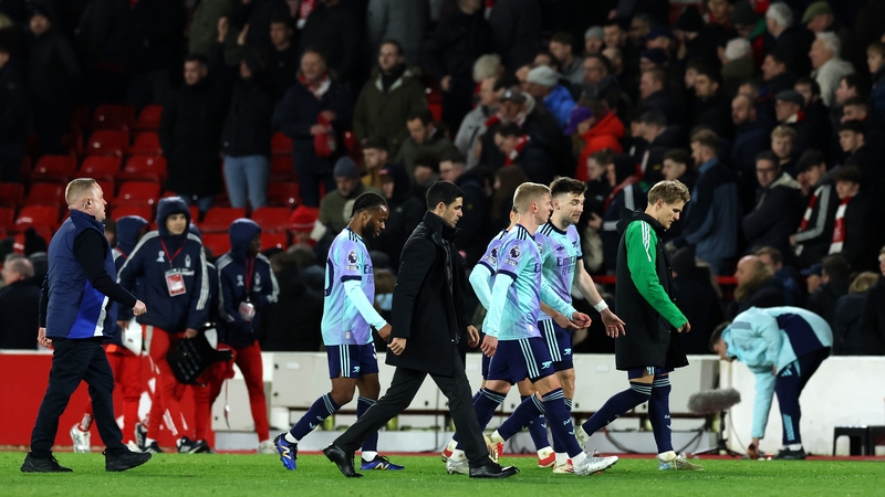 Mikel Arteta and Arsenal players leave the pitch after the 0-0 draw at the City Ground