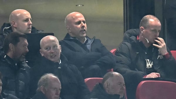 Arne Slot is flanked by members of Liverpool's backroom team in the stands at Anfield