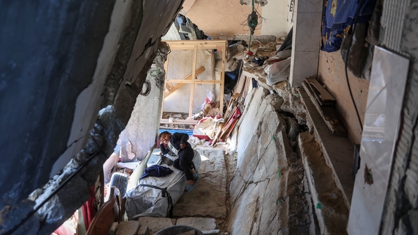 A Palestinian child rests in a destroyed building in Jabalia, northern Gaza