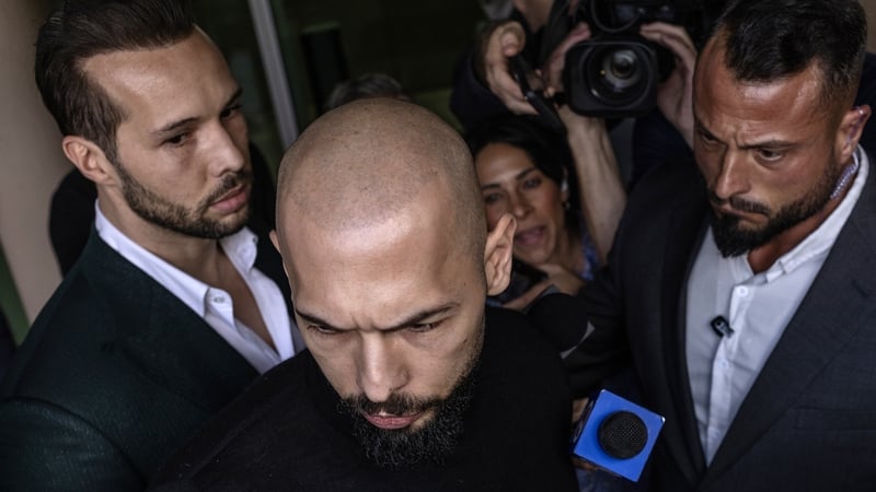 Andrew Tate (C) and Tristan Tate (L) arriving in the United States yesterday