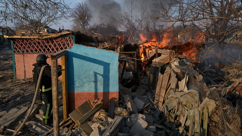 Firefighters extinguish a blaze at the scene of a bombing after Russian forces launched a missile at a residential area, killing at least three people in Kramatorsk, Ukraine