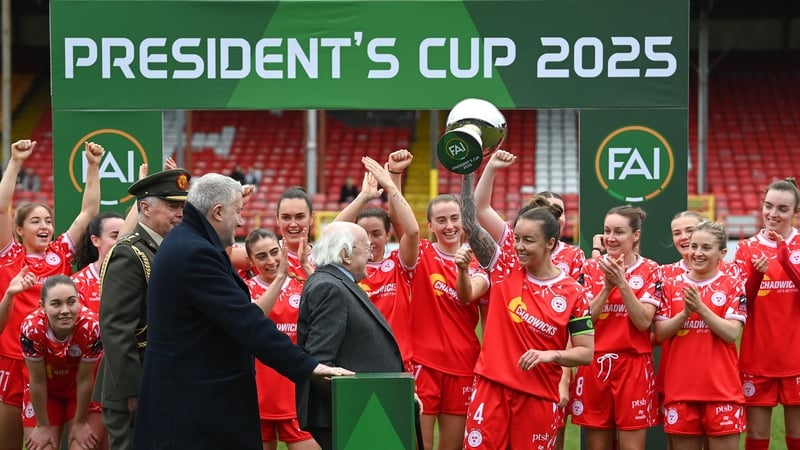 Shels captian Pearl Slattery is presented with the Cup by President Higgins