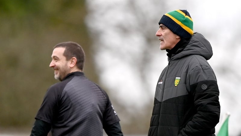 Jim McGuinness and line umpire Noel Mooney share a joke during today's clash at Ballybofey