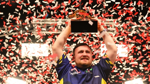 Luke Littler celebrates with the 2025 UK Open Trophy