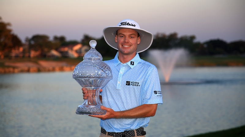 Joe Highsmith poses with the trophy after putting in to win on the 18th green