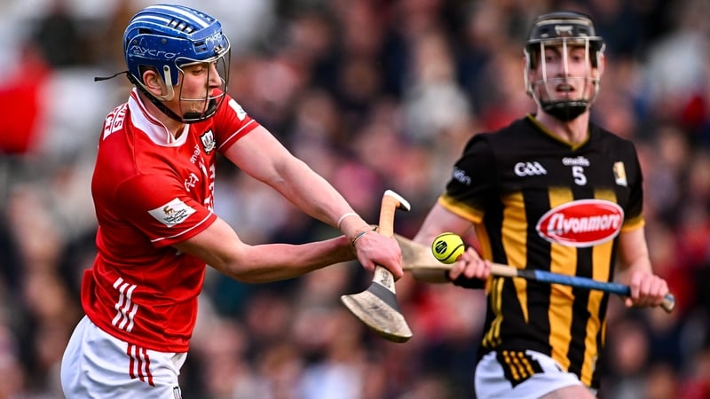 Cork's Diarmuid Healy scores a point as Kilkenny's David Blanchfield closes in